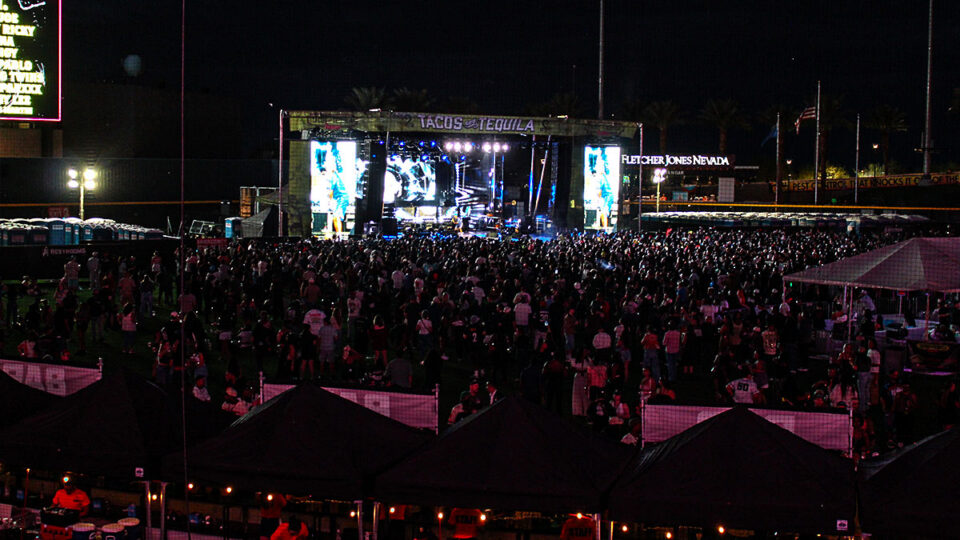 Nighttime crowd and illuminated main stage at Tacos & Tequila Festival at Las Vegas Ballpark
